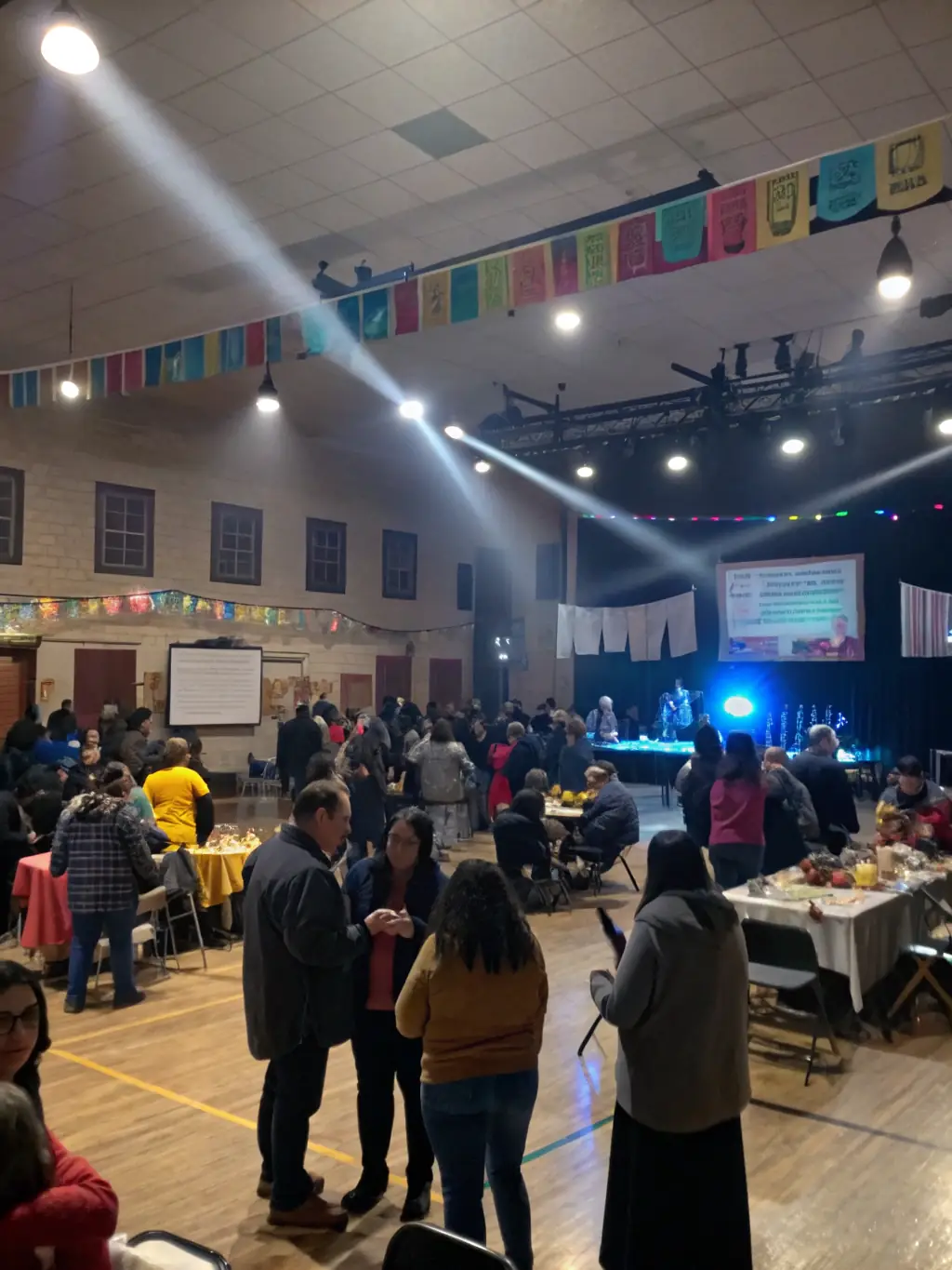 A photo of a public screening event of a locally produced film, with community members gathered to watch and discuss the content.